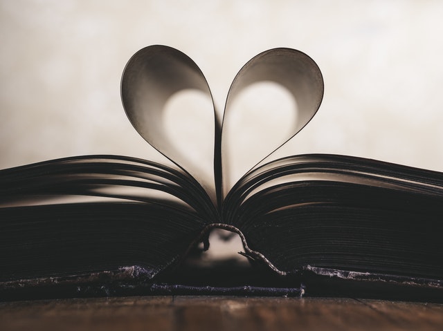 Shadowy heart image formed from folded book pages